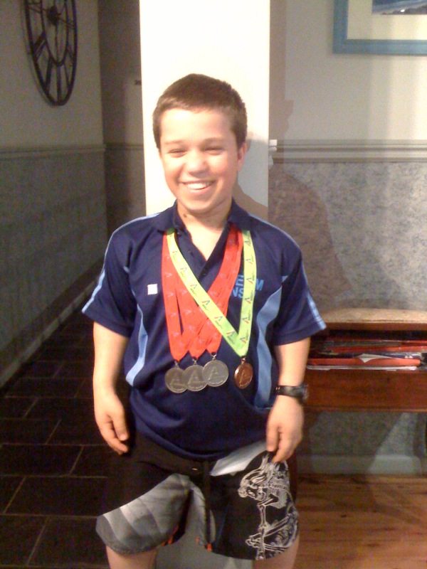 Reagan Wickens with his medals from the 2009 APYG